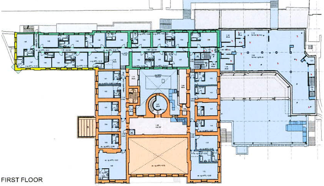 This is an architectural floor plan labeled 'FIRST FLOOR' showing the layout of rooms, corridors, and staircases within a building.