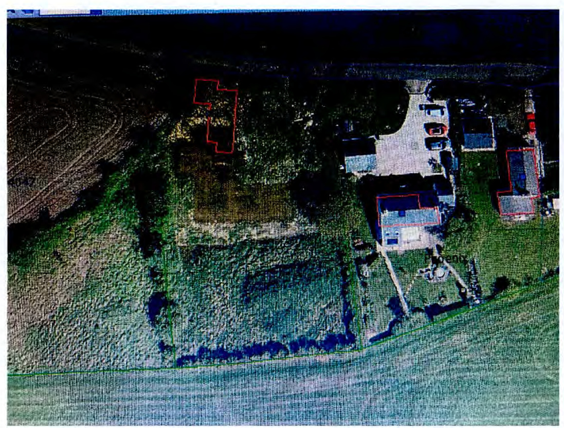 Aerial site plan showing a proposed development plot outlined in red adjacent to existing rural buildings and fields.