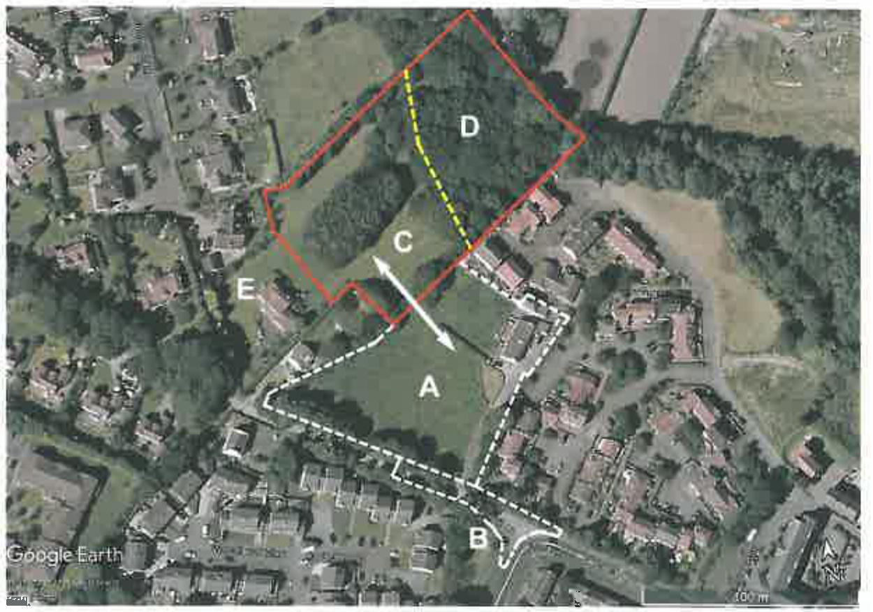An aerial site plan showing a large plot of land outlined in red with zones labeled A through E, situated near existing residential properties.