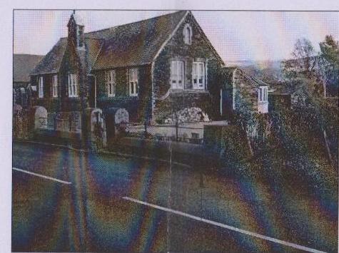 A grainy photograph showing the front elevation of a stone building, likely the existing detached dwelling mentioned in the application.