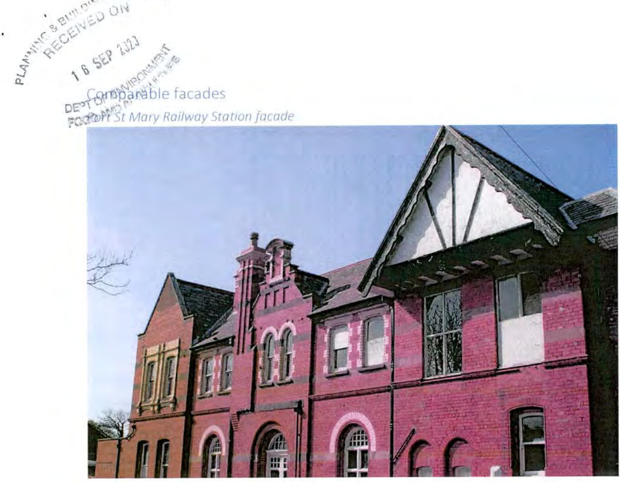 A photograph of the red brick Port St Mary Railway Station facade, included as a design comparison for a new dwelling application.