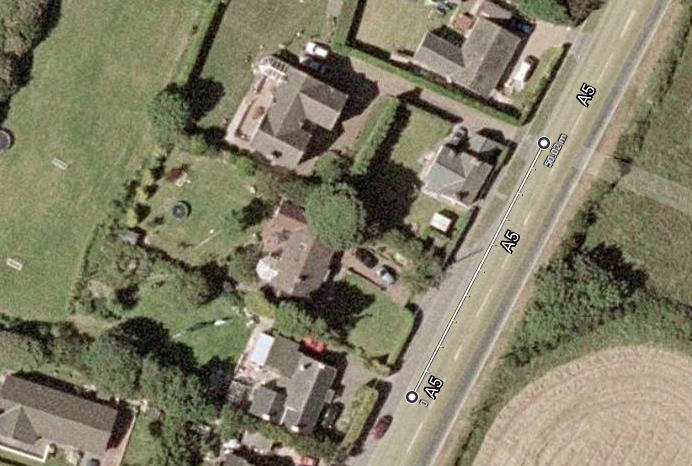 Aerial site location map showing existing residential properties along the A5 road with a measurement line indicating 50.00m.