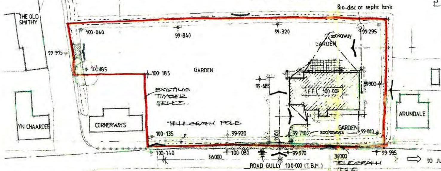 A hand-drawn site plan illustrating property boundaries, existing structures, and proposed drainage infrastructure including a soakaway and septic tank.