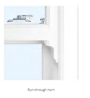 A close-up technical photograph of a white window frame corner detail, specifically showing the meeting rail and hardware labeled 'Run-through horn'.