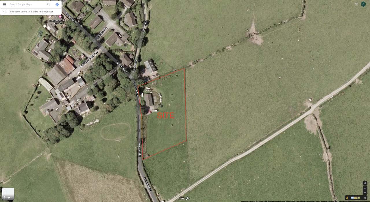 Aerial satellite view showing a specific plot of land outlined in red and labeled 'SITE' adjacent to existing residential properties and a road.