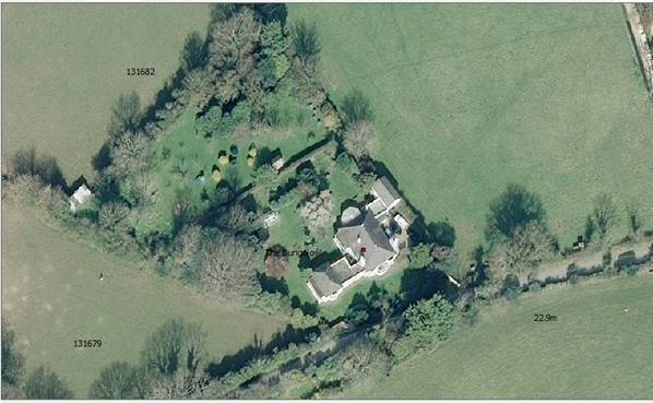 An aerial site location map showing a rural property with a house, trees, and surrounding agricultural fields.