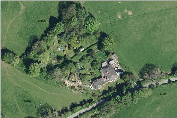 Aerial view of a rural property showing a house labeled 'The Bungalow' surrounded by green fields and trees.
