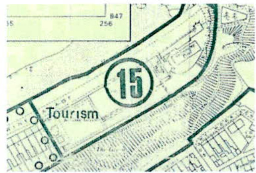 A close-up section of a site plan or OS map showing a designated area labeled 'Tourism' with a circled number 15, surrounded by building outlines and contour lines.