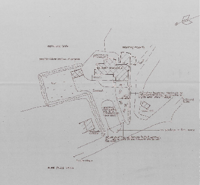 A rough hand-drawn site plan illustrating the property layout, existing buildings, and proposed development boundaries.
