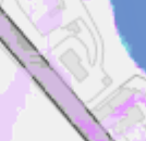 A zoomed-in section of a site location map showing a coastal area with buildings, roads, and land boundaries.