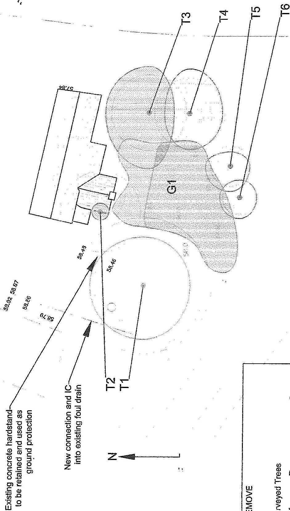 A technical site plan showing the footprint of an existing building, tree locations, and annotations for drainage and ground levels.