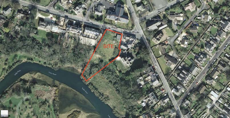 This image displays an aerial site location map with a specific plot of land outlined in red and labeled 'SITE'. The site is situated adjacent to the Sulby River and near existing residential properties.