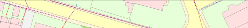 A site plan showing a road with adjacent land parcels and proposed site boundaries marked by dashed lines.