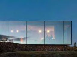 A photorealistic architectural rendering of a modern, single-story detached house featuring a stone base and extensive glass glazing, set against a twilight sky.