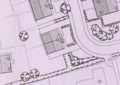 A black and white site plan showing the layout of a rural property, including building footprints, trees, and a curving driveway.