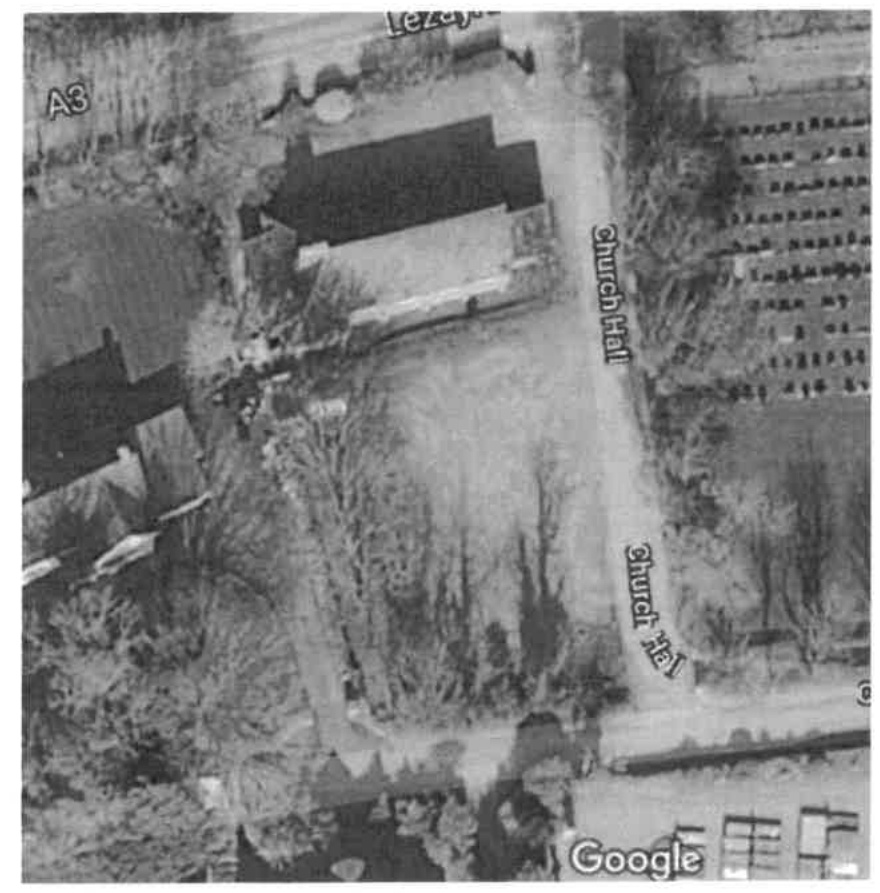 Aerial site location plan showing a building complex and road labeled Church Hall in Lezayre.