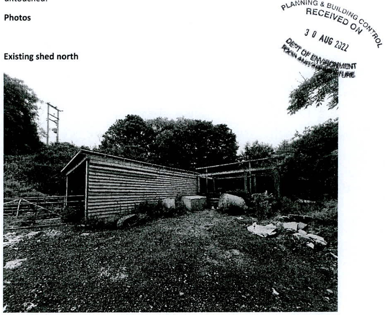 A black and white photograph showing an existing agricultural shed and an adjacent open structure, labeled 'Existing shed north'.