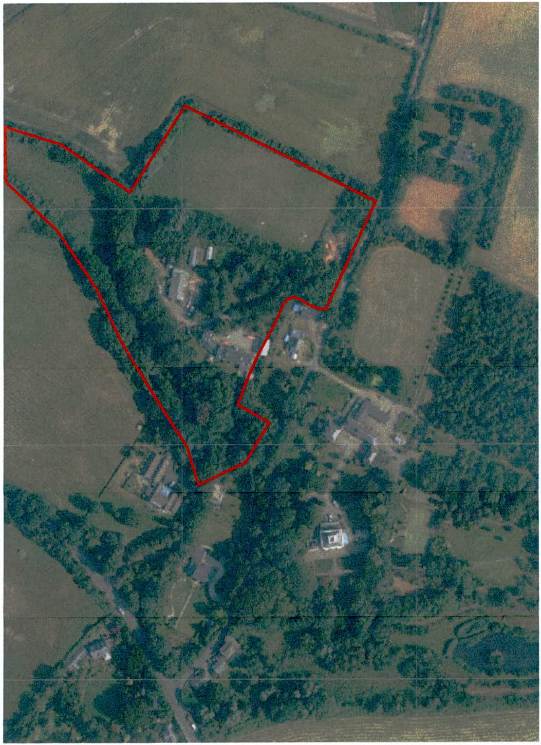 An aerial view of a rural site with a red line outlining the specific application area boundary.