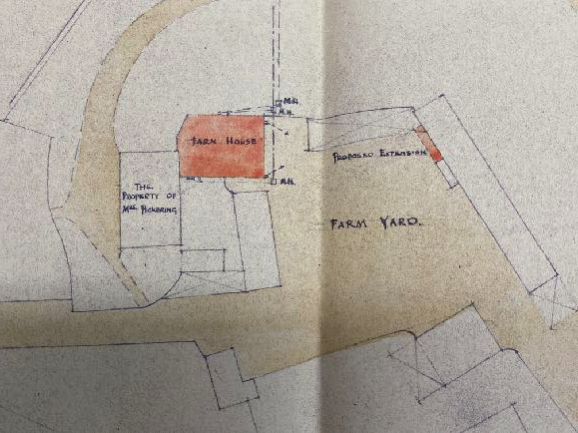 A hand-drawn site plan sketch showing the existing farm house, a proposed extension, and the surrounding farm yard and neighboring property boundaries.