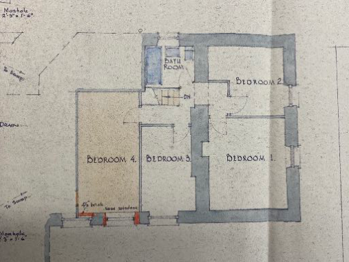 This image displays a hand-drawn architectural floor plan sketch showing a residential layout with four bedrooms and a bathroom. It includes wall dimensions and construction notes along the edges.