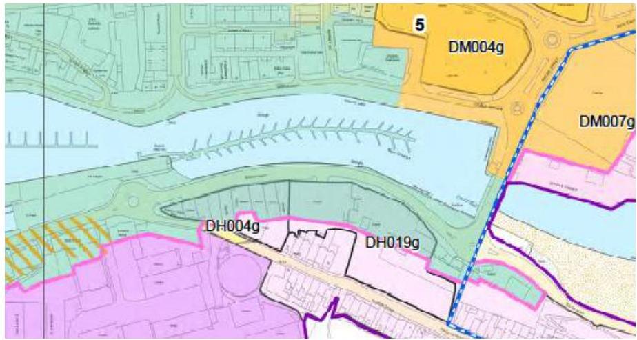 A colored planning map showing land use zones and designations around a marina or harbor area with road networks.