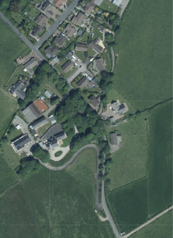 Aerial site location map showing a rural property with multiple buildings, roads, and surrounding green fields.