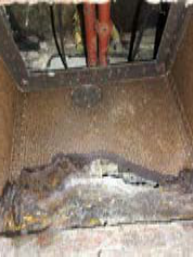 A low-resolution close-up photograph showing a window frame or opening detail with vertical bars and a rusty latch mechanism.