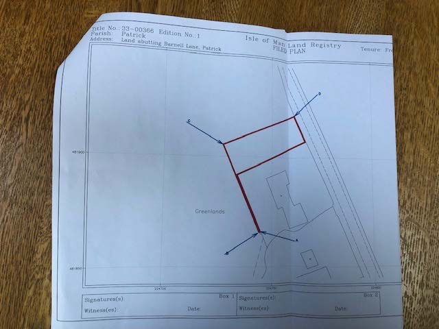 A scanned Isle of Man Land Registry Filed Plan showing a property boundary outlined in red ink on a map of land in Patrick parish.