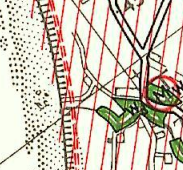 A close-up view of a site plan or map showing property boundaries, green shaded areas representing vegetation, and red grid lines.