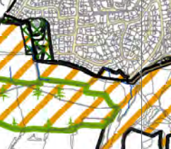 A site plan showing a specific plot outlined in black, surrounded by orange hatched zones and green areas with tree symbols, set against a background of a street grid.