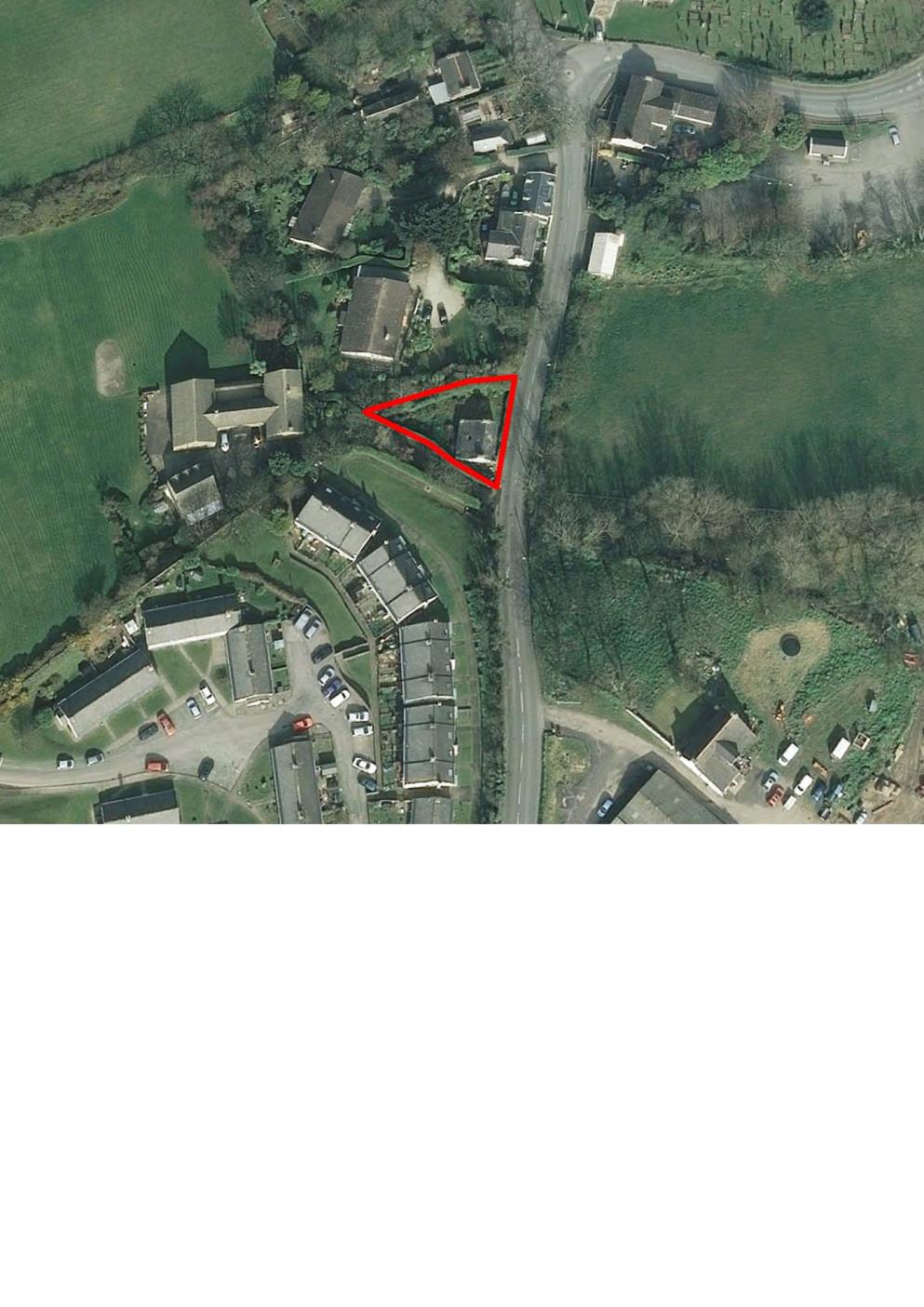 An aerial site location map showing a specific plot of land outlined in red, situated near a road and existing residential properties in a rural setting.