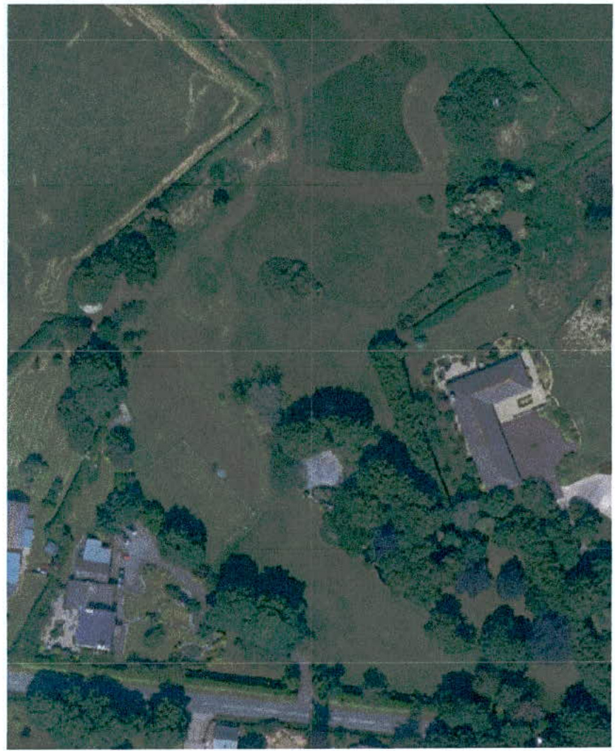 An aerial site plan showing a rural property with fields, trees, and surrounding buildings.