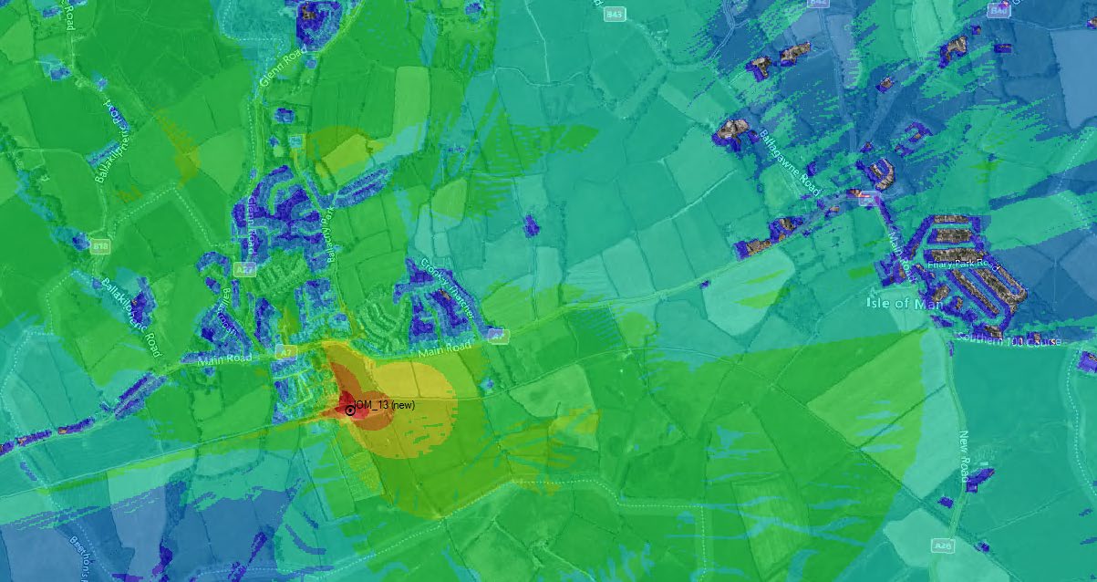 A digital heat map overlay showing mobile network signal coverage over a rural landscape, highlighting a proposed new site location labeled 'GSM 13 (new)'.