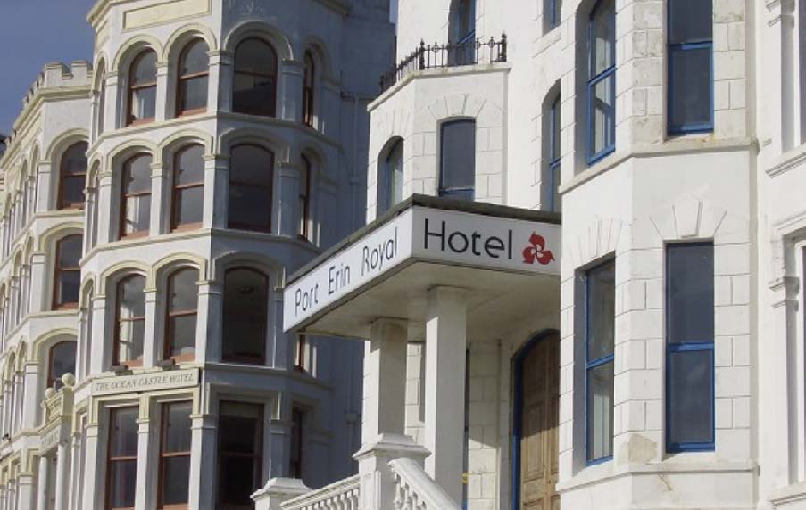 A photograph showing the exterior facade of the Port Erin Royal Hotel and The Scenic Castle Hotel, featuring white stone architecture and bay windows.