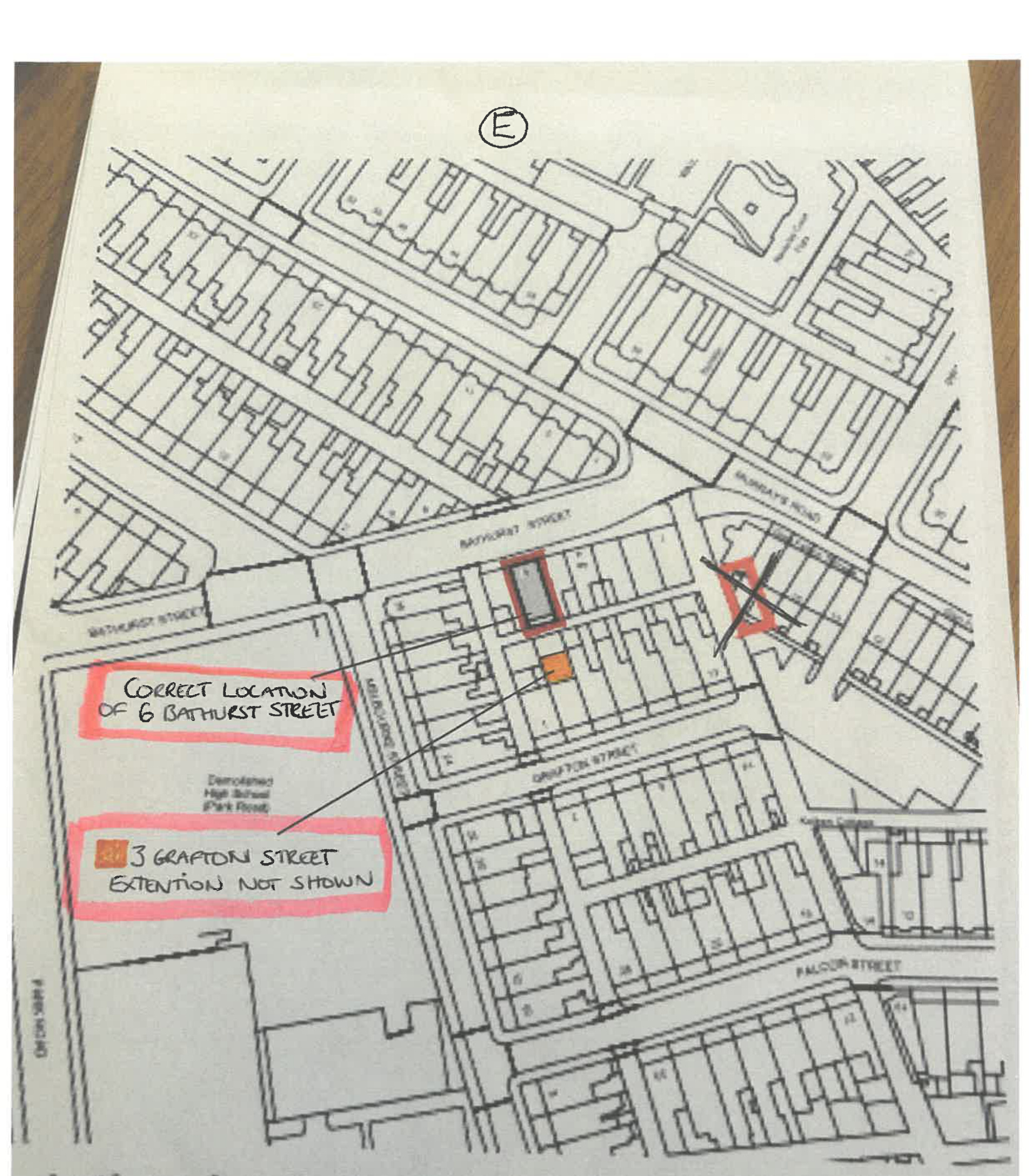 A location map showing a residential street layout with handwritten red annotations correcting property locations and noting an extension.