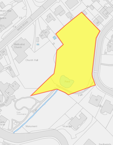 This image displays a site location plan with a specific plot of land highlighted in yellow and outlined in red. It shows surrounding features such as a Methodist Church, Church Hall, and Main Road.