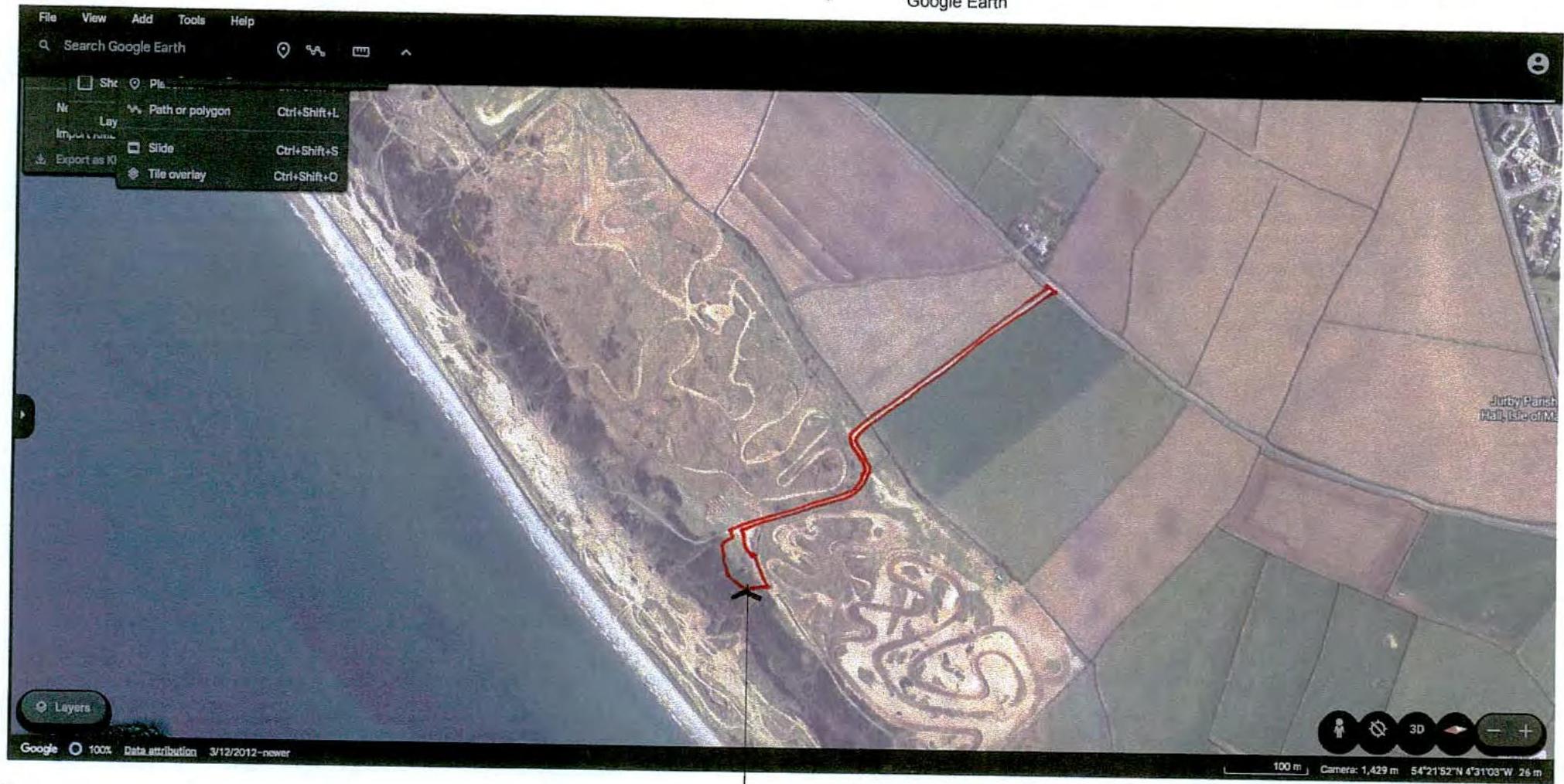 A screenshot of Google Earth showing a coastal site location with a large hillside geoglyph and a red boundary line.