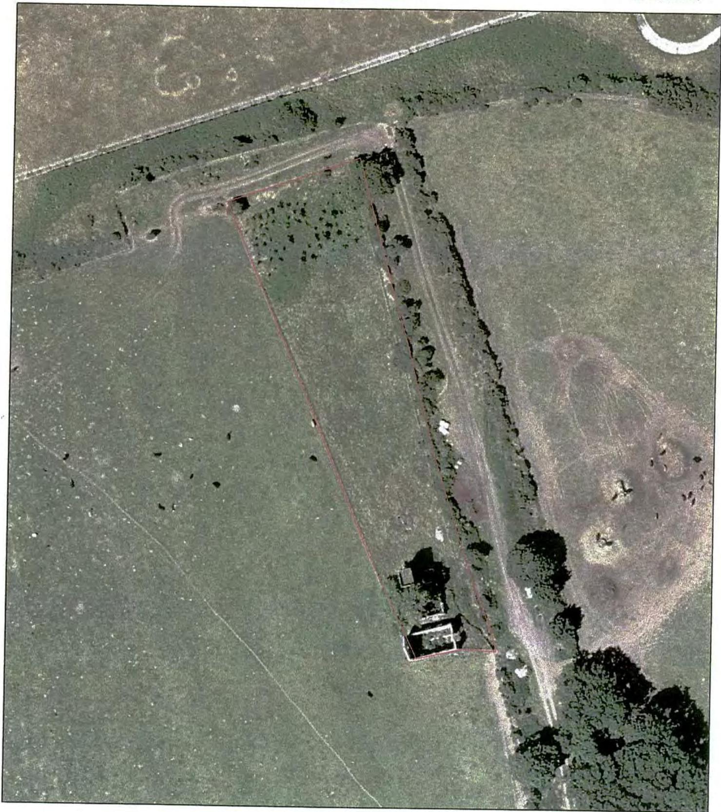An aerial photograph showing a rural property with a red boundary line outlining the site.