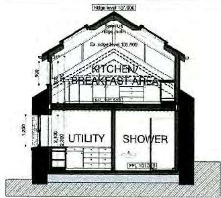 Architectural section drawing showing the internal layout of a kitchen, utility, and shower area within a pitched roof structure.