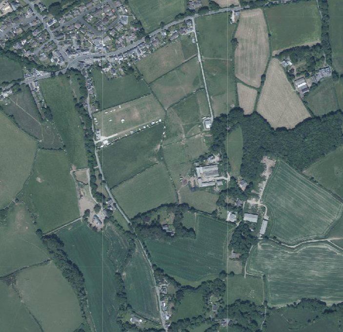 An aerial view or satellite map showing a rural landscape with fields, roads, and buildings, serving as a location plan for the application.