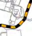 A zoomed-in section of a site plan showing a road with black and yellow markings and adjacent property boundaries.
