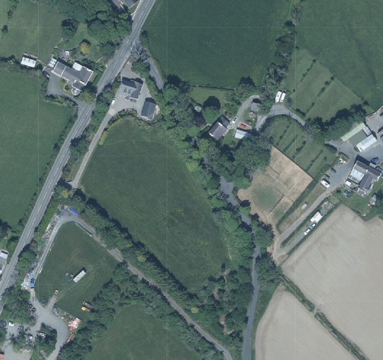 Aerial site location map showing a rural area with fields, roads, and scattered buildings.
