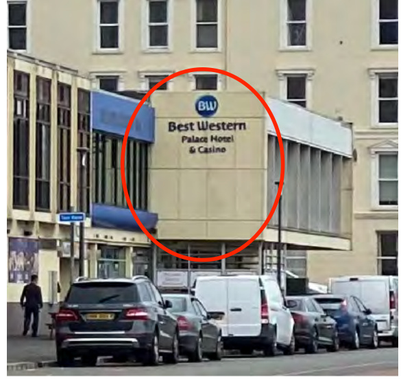 A street-level photograph showing the exterior facade of the Best Western Palace Hotel & Casino with the main sign circled in red.