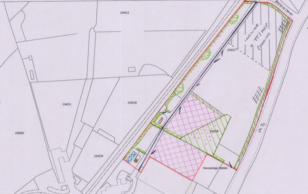 A site plan showing land parcels, road boundaries, and proposed areas marked with pink and green hatching near Pennybridge Stables.