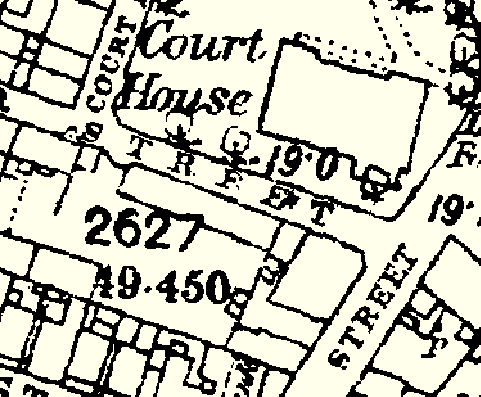 A black and white historical map or site plan showing property boundaries, building footprints, and street names such as 'Court House Street'.