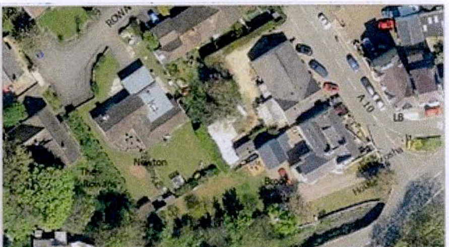 An aerial photograph serving as a location map, displaying a rural residential area with house names and road labels.