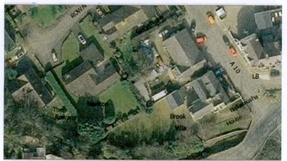 Aerial satellite map showing a residential area with property names like 'The Rowans' and 'Brook Mills' overlaid.