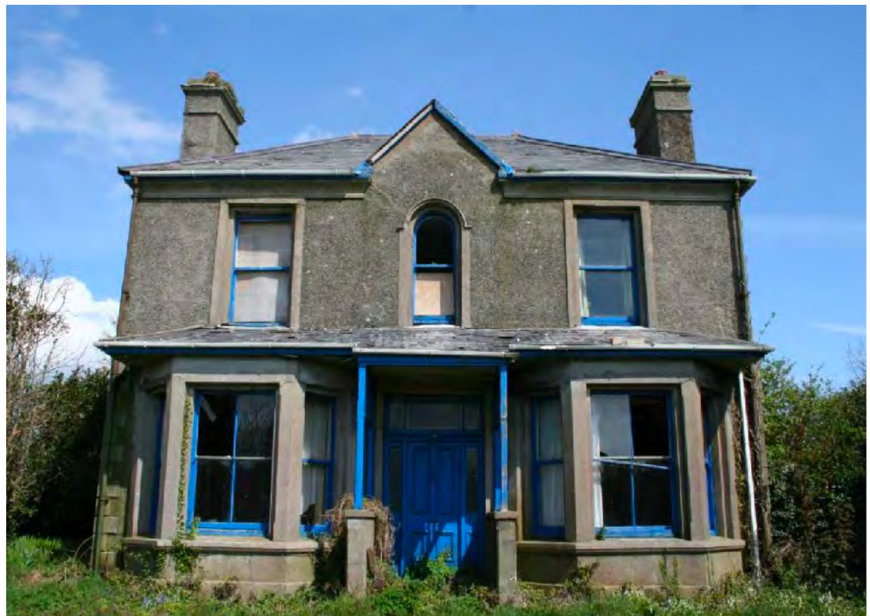 A photograph of a two-story detached house with pebbledash rendering, showing signs of renovation with blue tape around the window frames.