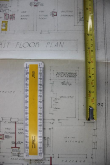 An architectural drawing showing a first-floor plan with room labels like 'Scullery' and 'Main Kitchen', overlaid with measuring rulers.