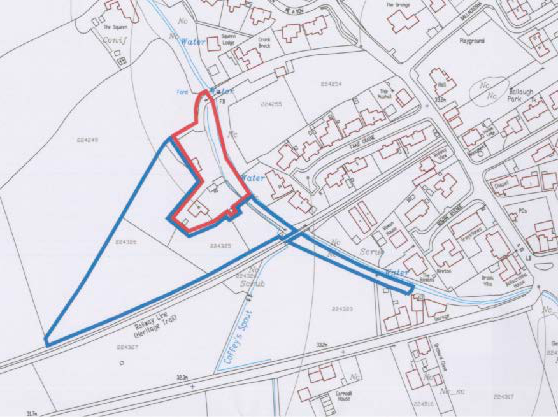 A site plan map displaying a proposed development plot outlined in red and a larger boundary in blue, located near Station Road in Ballaugh.